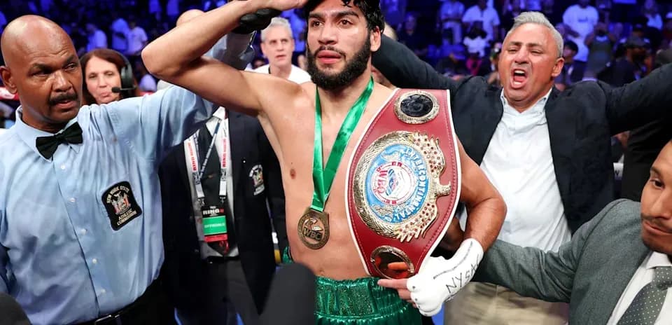 Boxer celebrating victory with championship belt