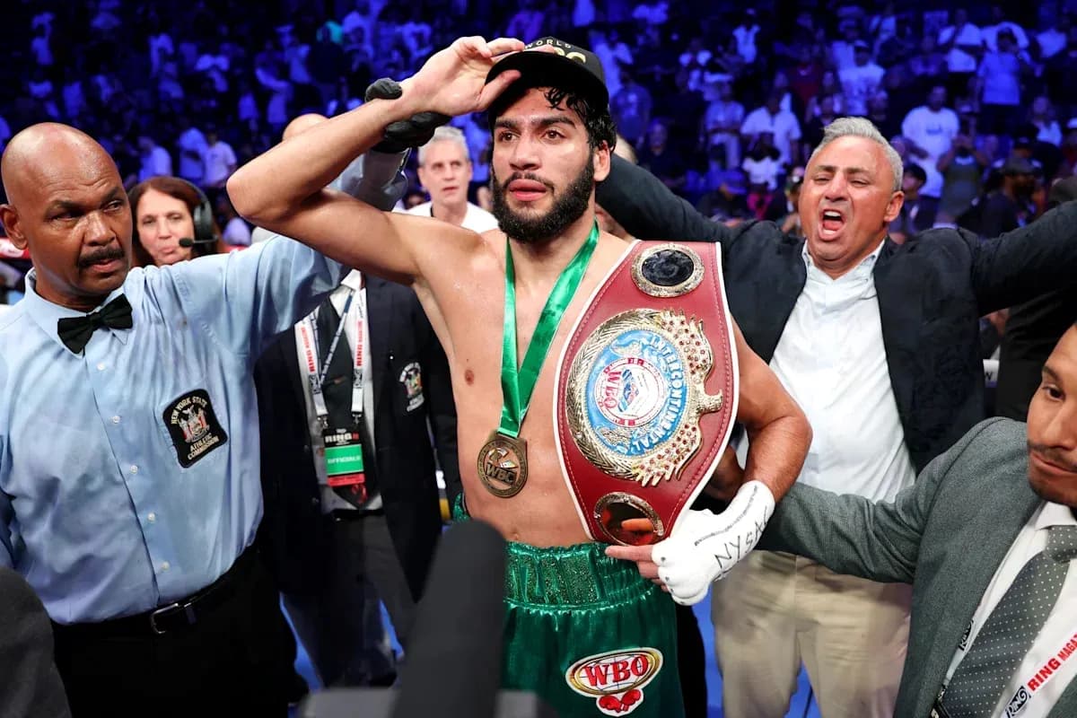 Boxer celebrating victory with championship belt