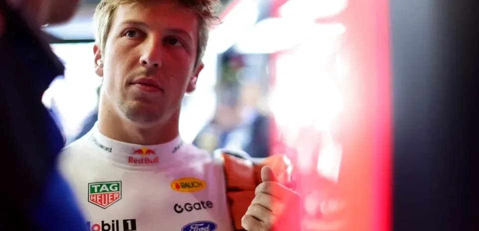 Driver in racing suit preparing for session