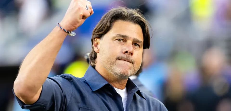 Coach celebrating with fist raised on field