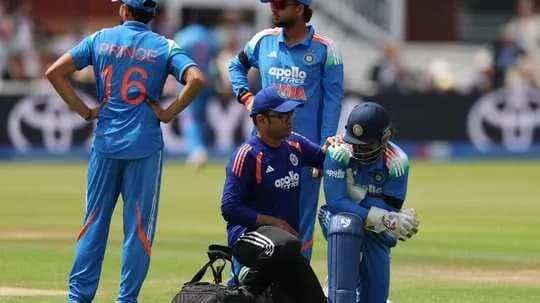 Cricket players and medical staff attending to injured player
