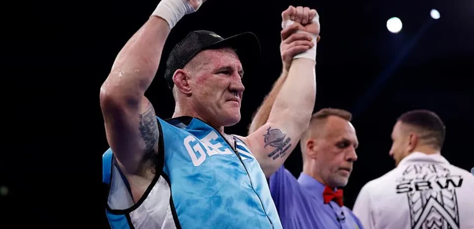 Boxer celebrating victory with referee in ring