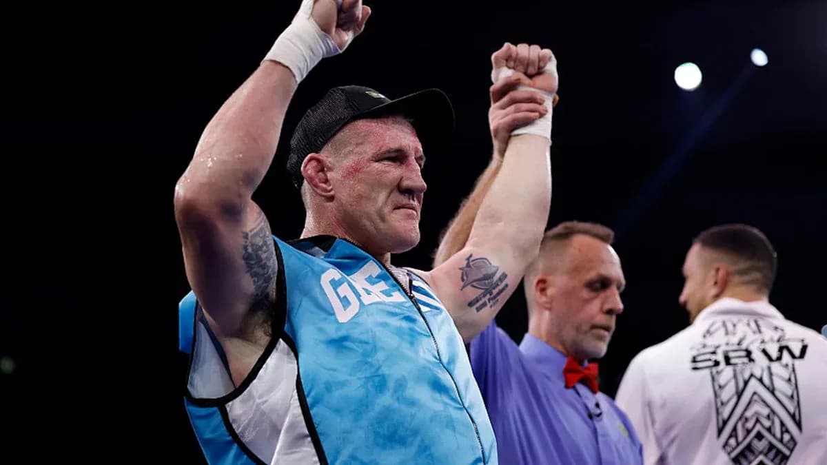 Boxer celebrating victory with referee in ring