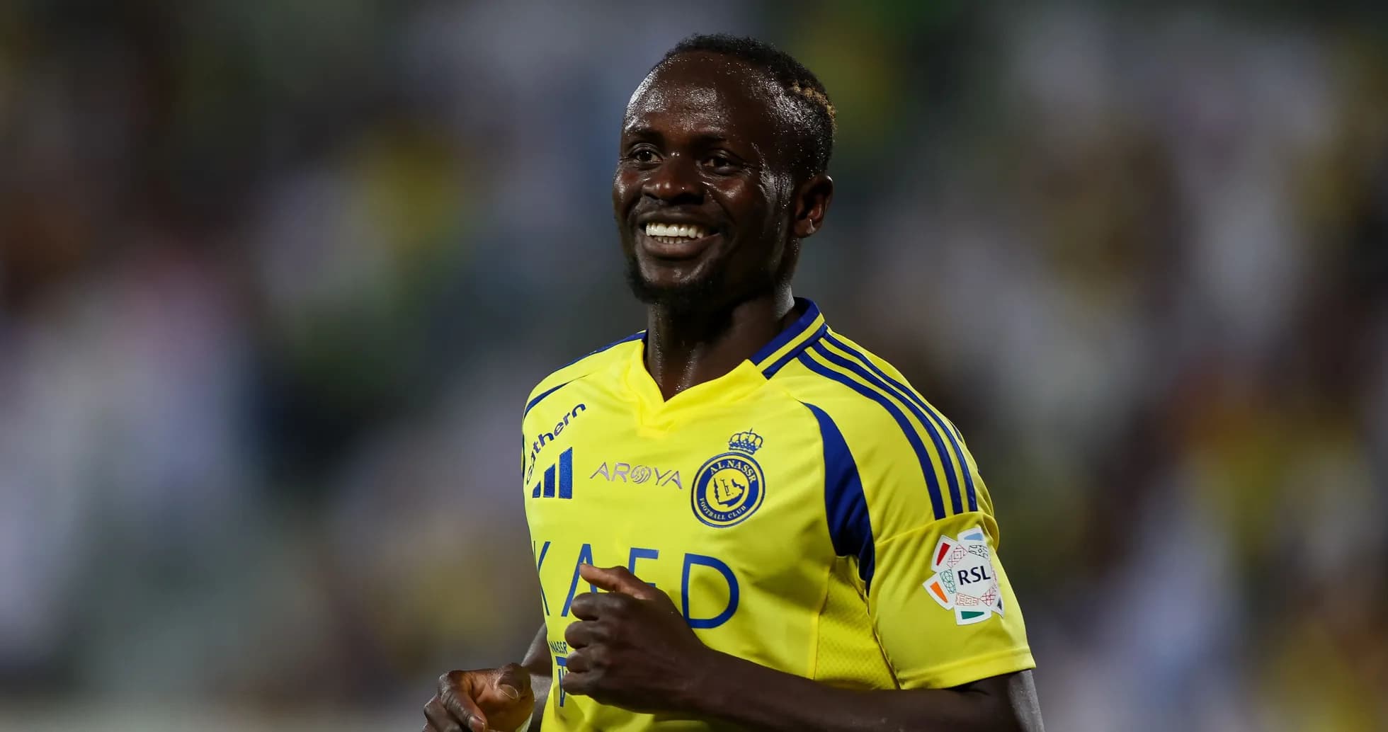Player celebrating in Al Nassr yellow jersey