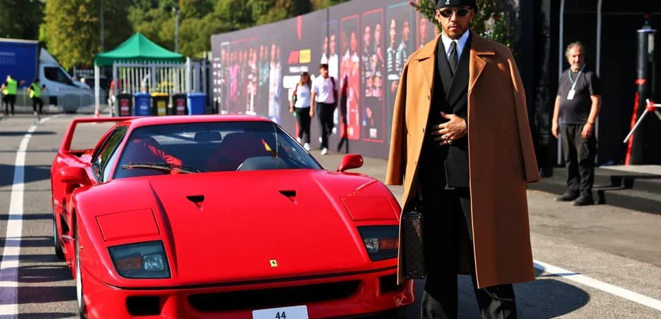 Person in stylish outfit next to red sports car
