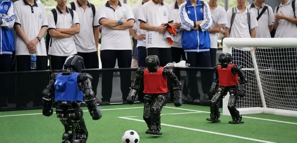 Robots playing soccer with spectators watching