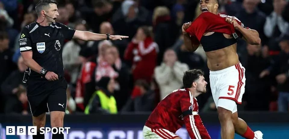 Referee signals during intense match celebration