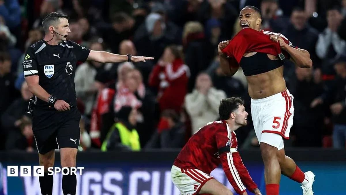 Referee signals during intense match celebration