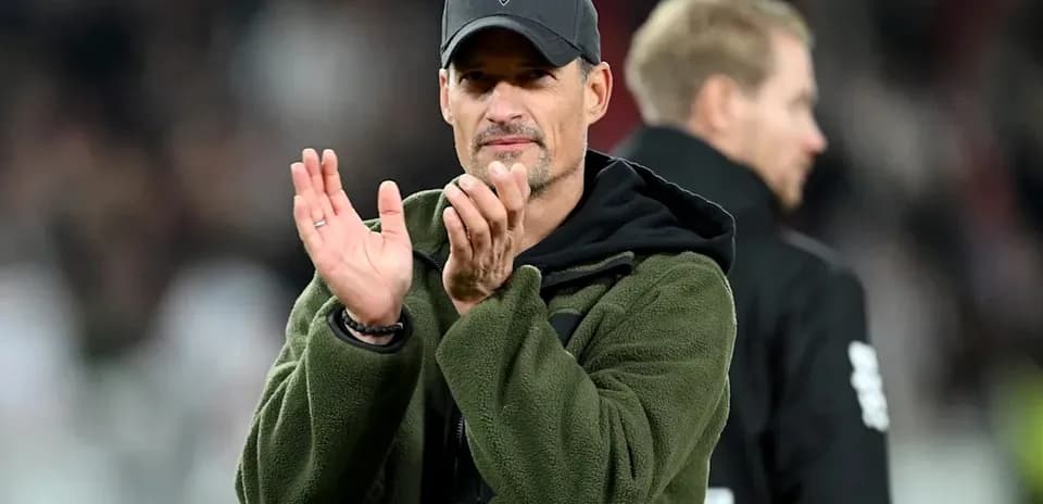 Coach applauding during a football match