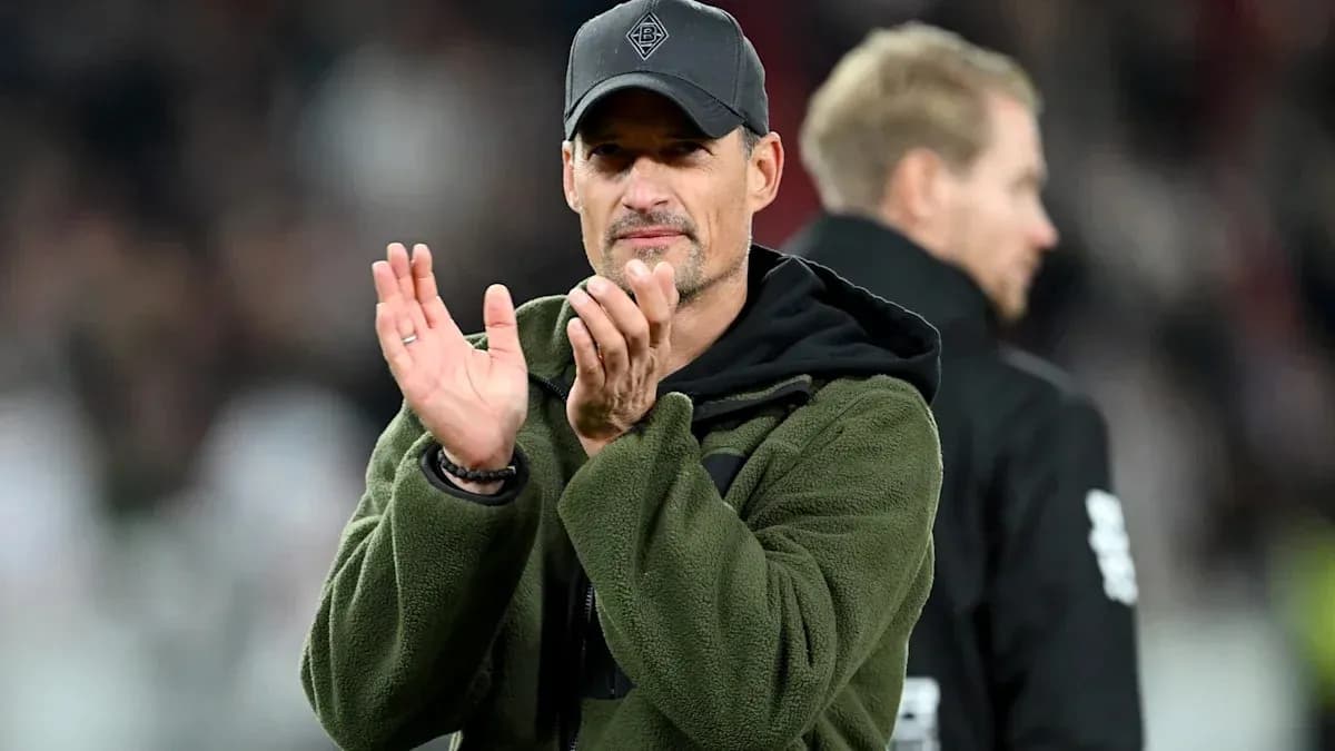 Coach applauding during a football match