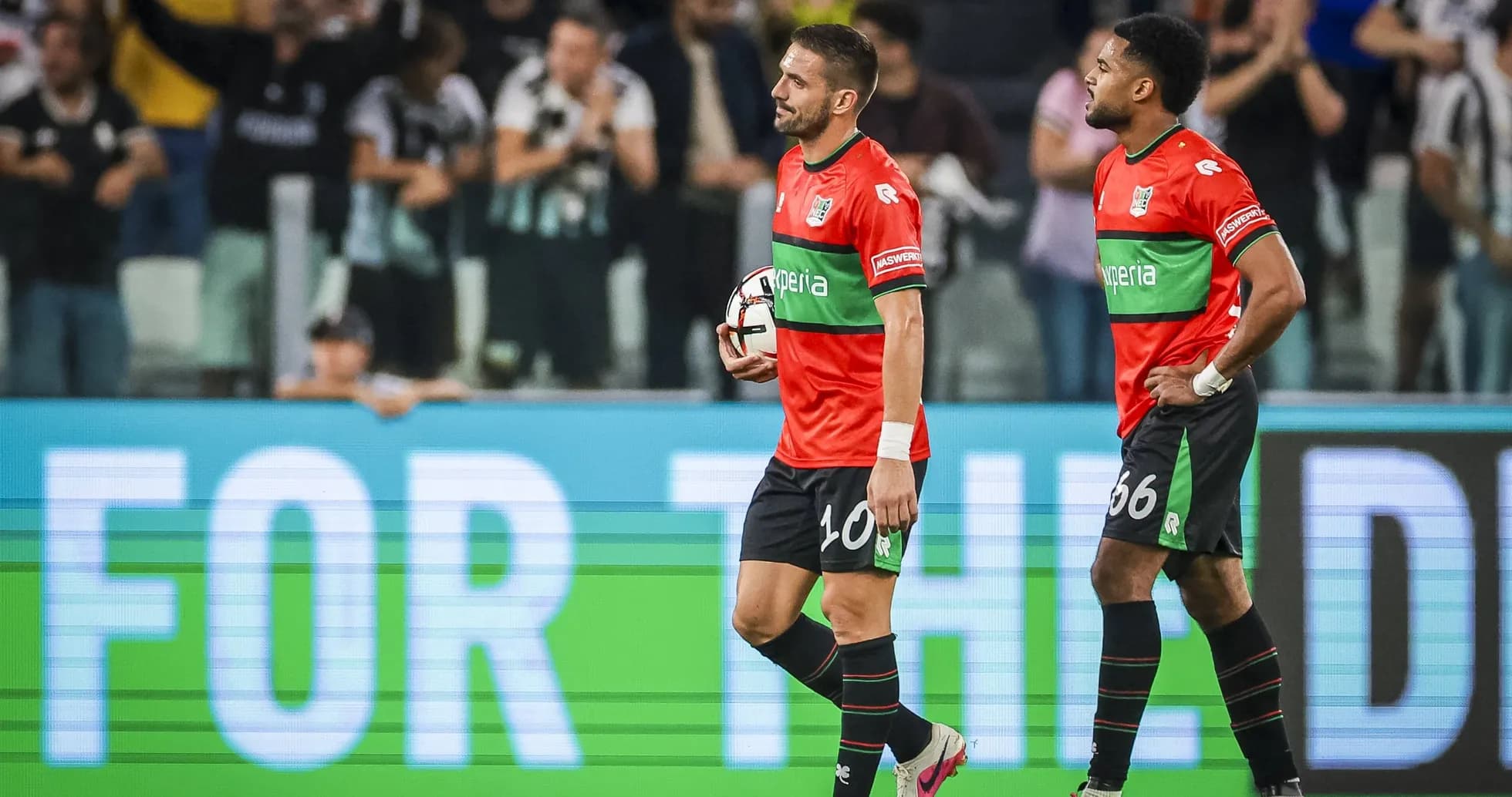 Two players walking off field after match