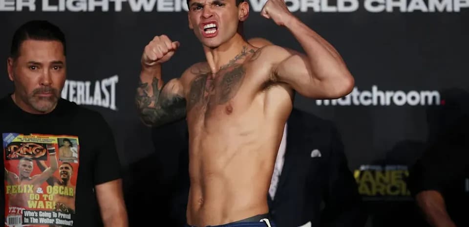Boxer posing during weigh-in event with team member