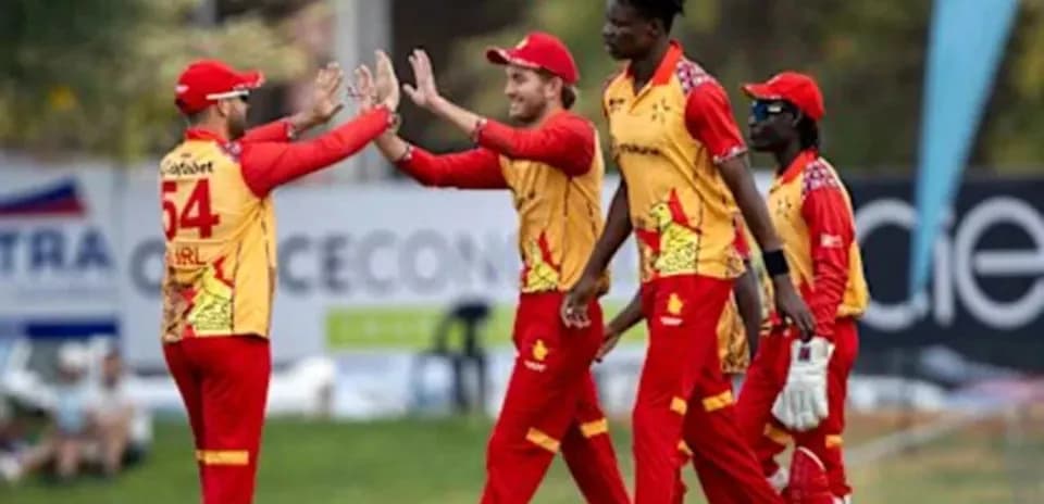 Cricket team celebrating a wicket on the field