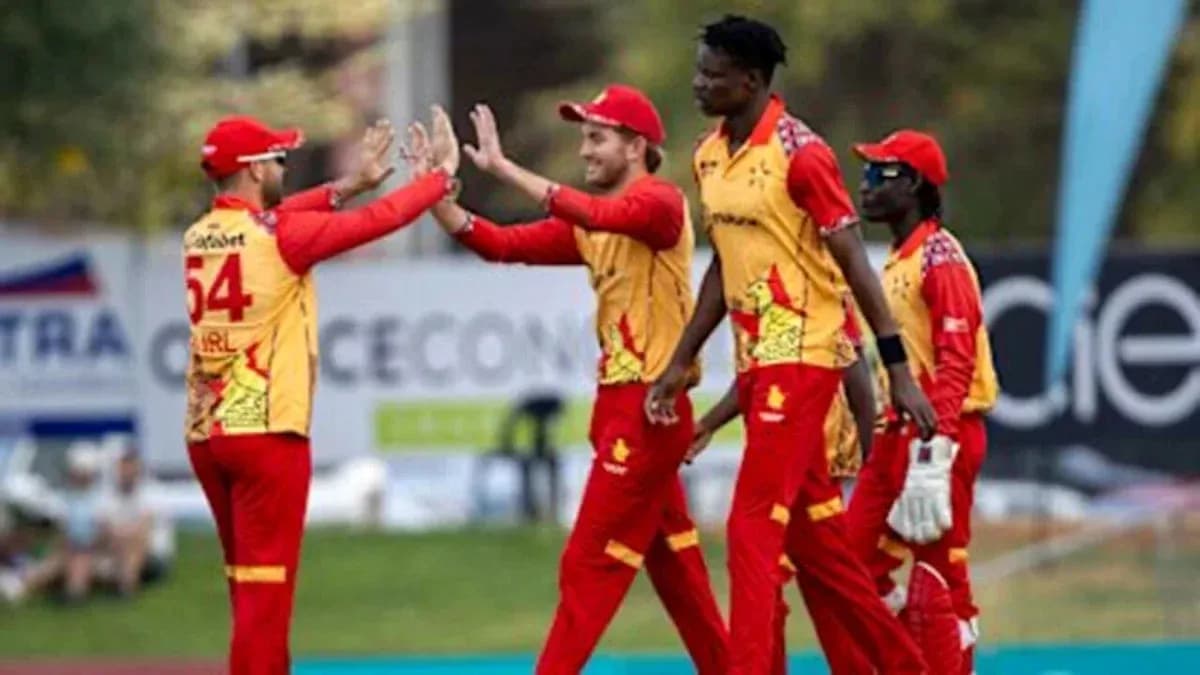 Cricket team celebrating a wicket on the field