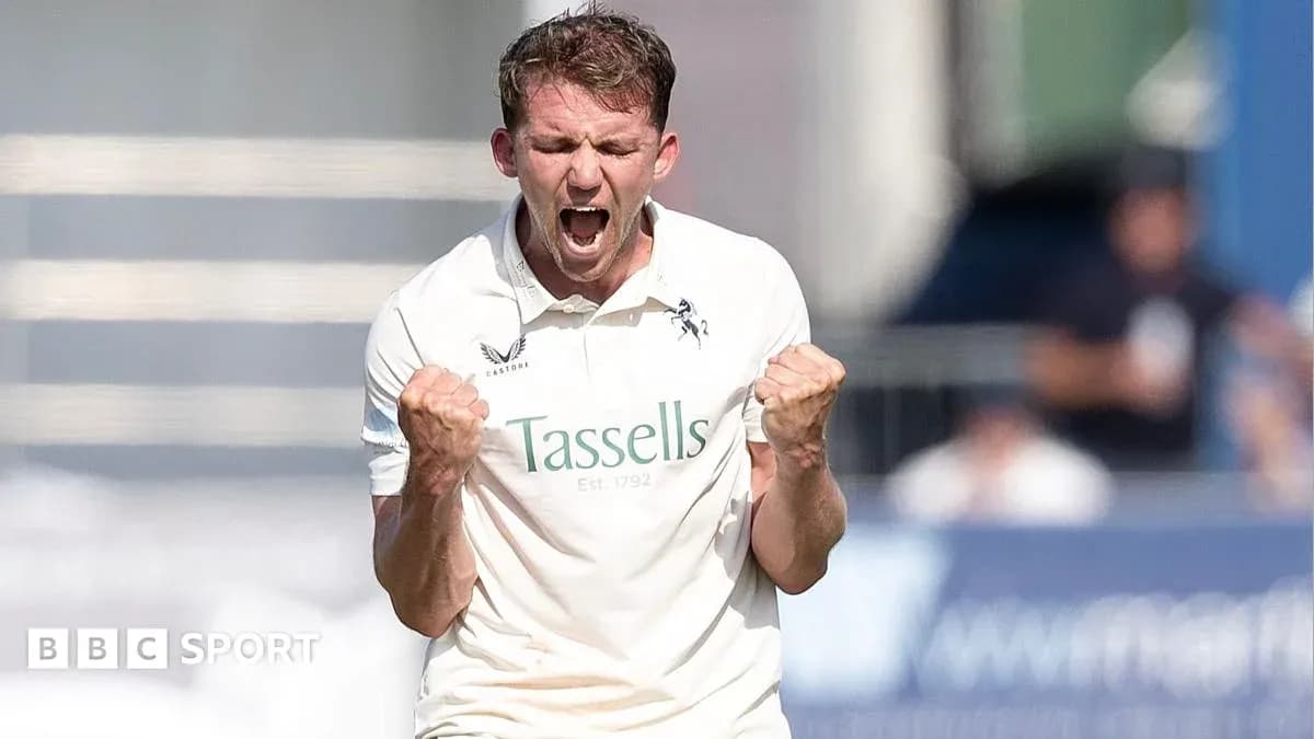 Cricketer celebrating a wicket with clenched fists