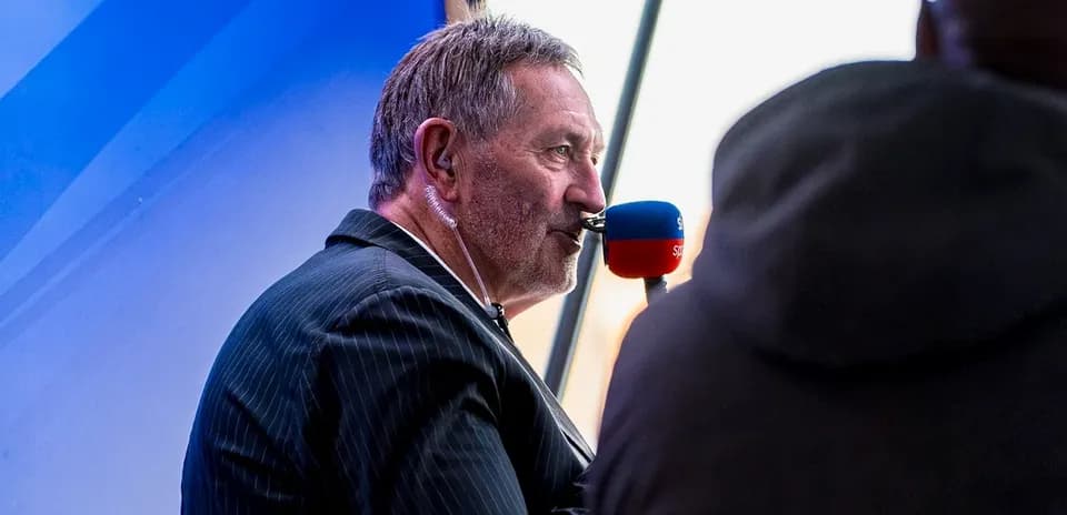 Commentator speaking into microphone at event