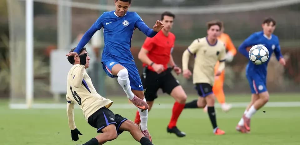 Chelsea player evading a tackle during youth match