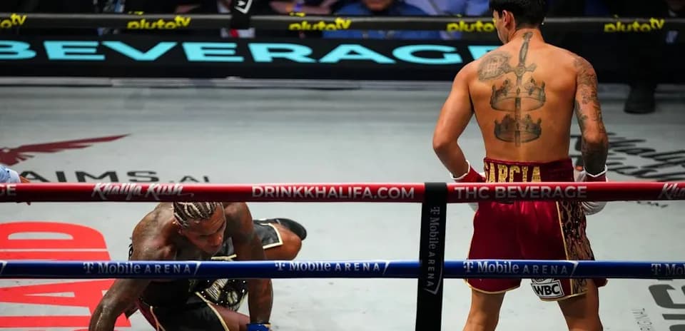 Boxer on the canvas with opponent standing nearby
