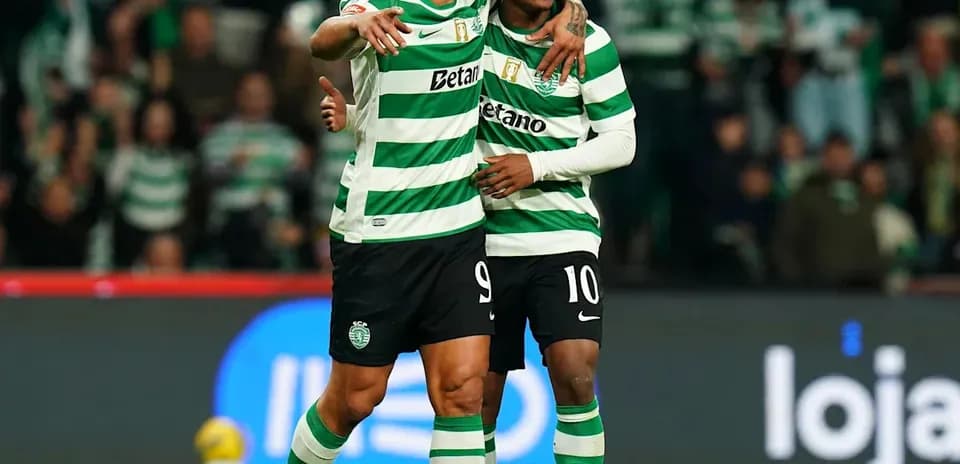 Two Sporting CP players celebrating a goal together