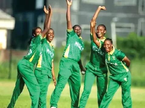 Five Nigerian female cricketers celebrating on field