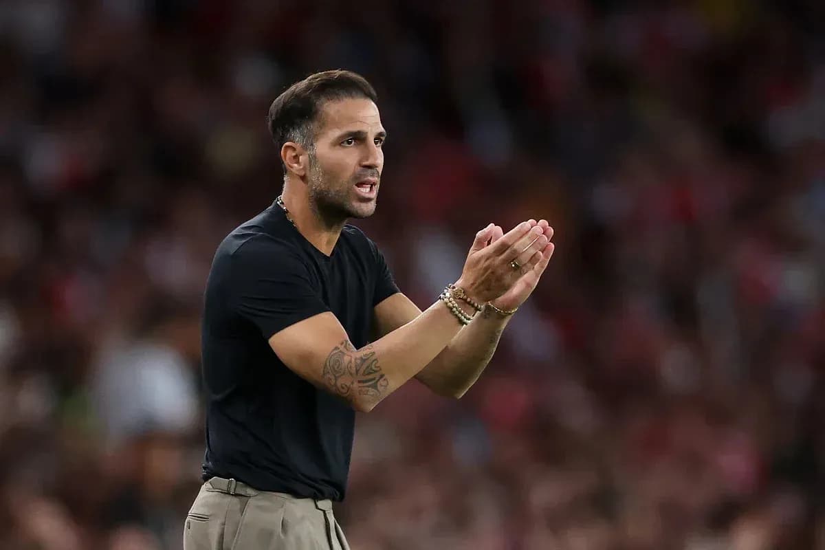 Coach gesturing and directing players during match