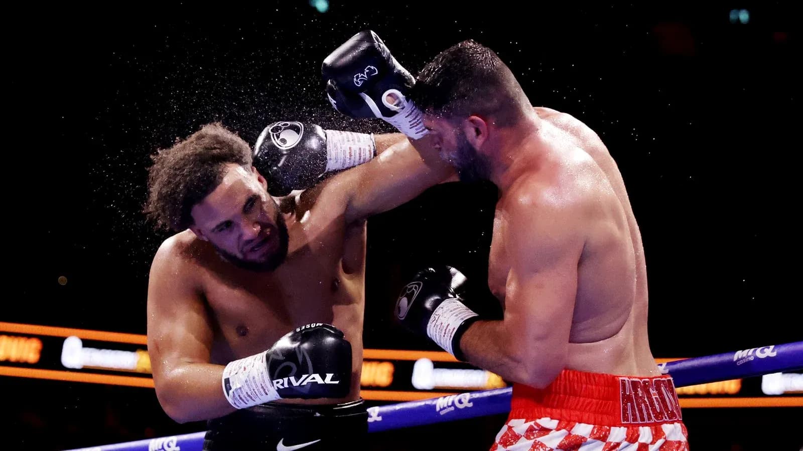 Boxers exchanging punches in the ring