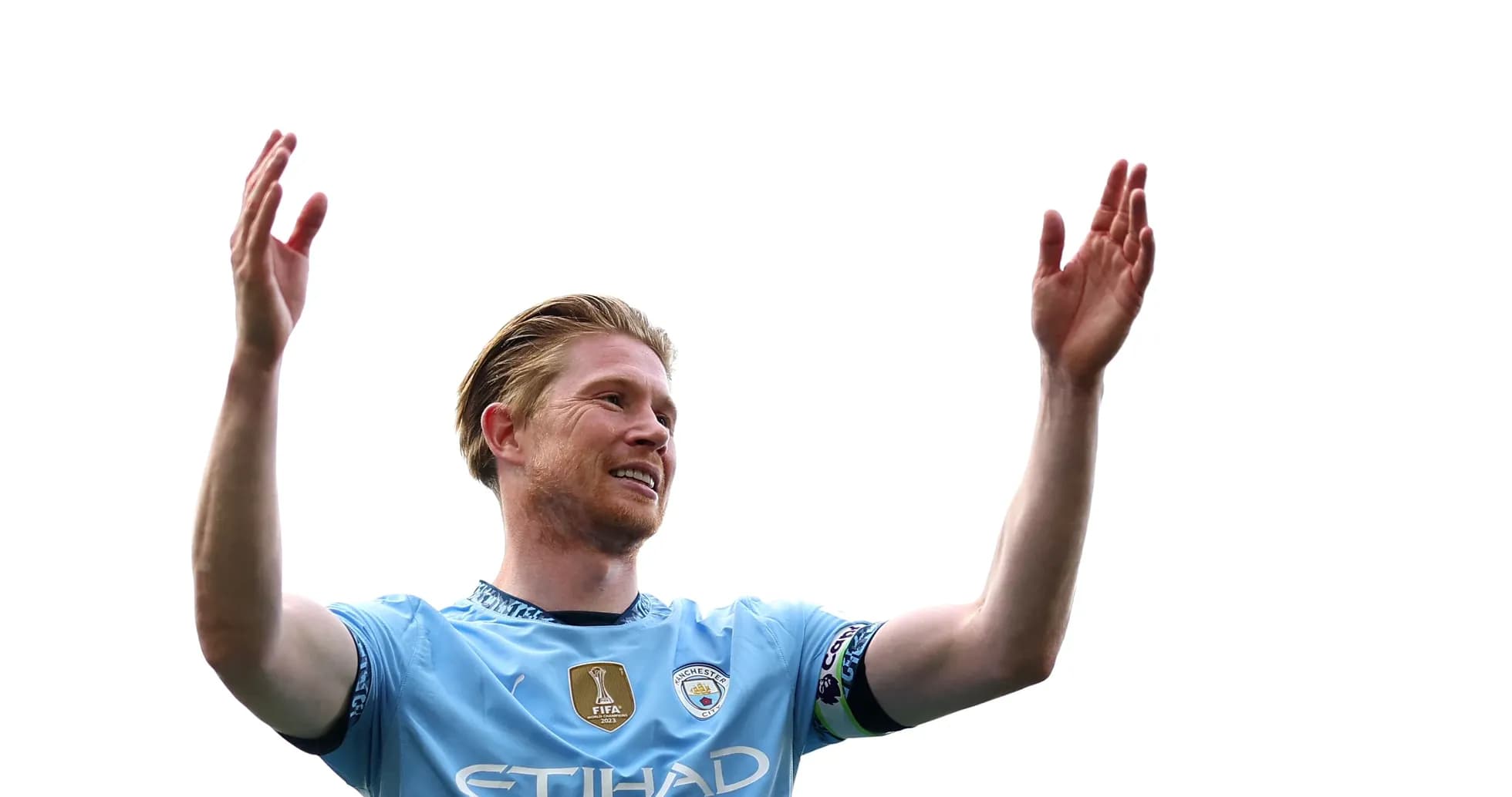 Player celebrating with raised arms in Manchester City kit