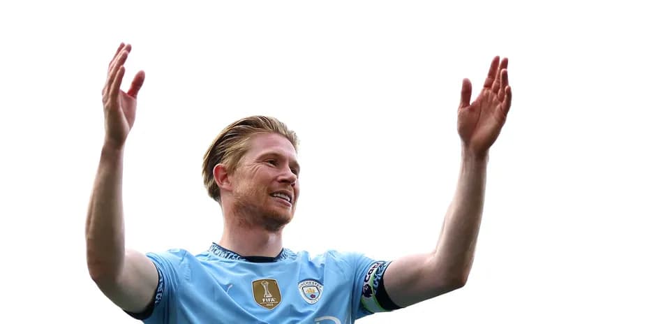 Player celebrating with raised arms in Manchester City kit