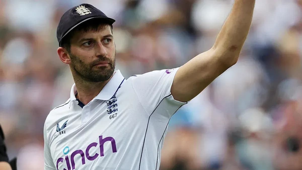 Cricketer gesturing during a match in white kit