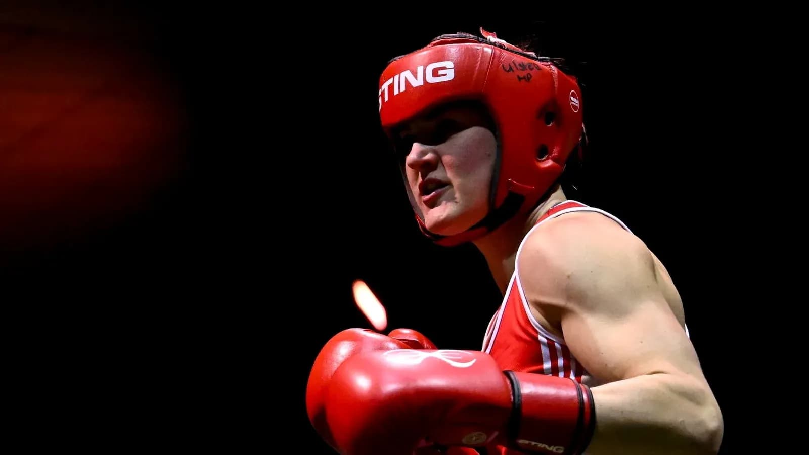 Boxer in red gear preparing for a match
