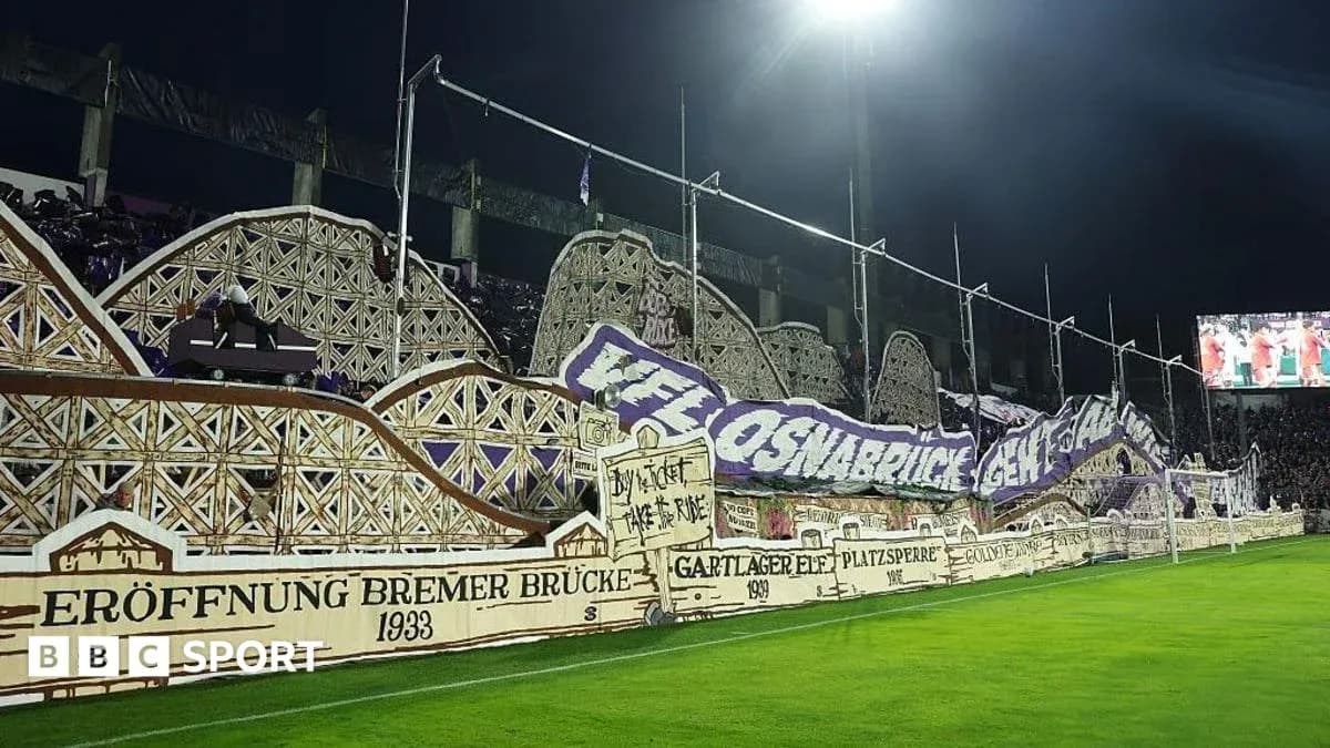 Fans displaying large banners in stadium stands