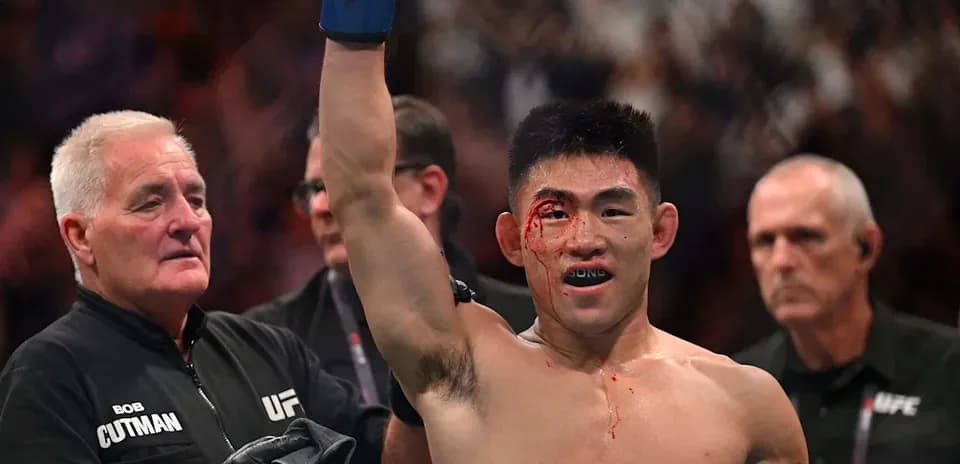 Fighter celebrating victory with a bloodied face