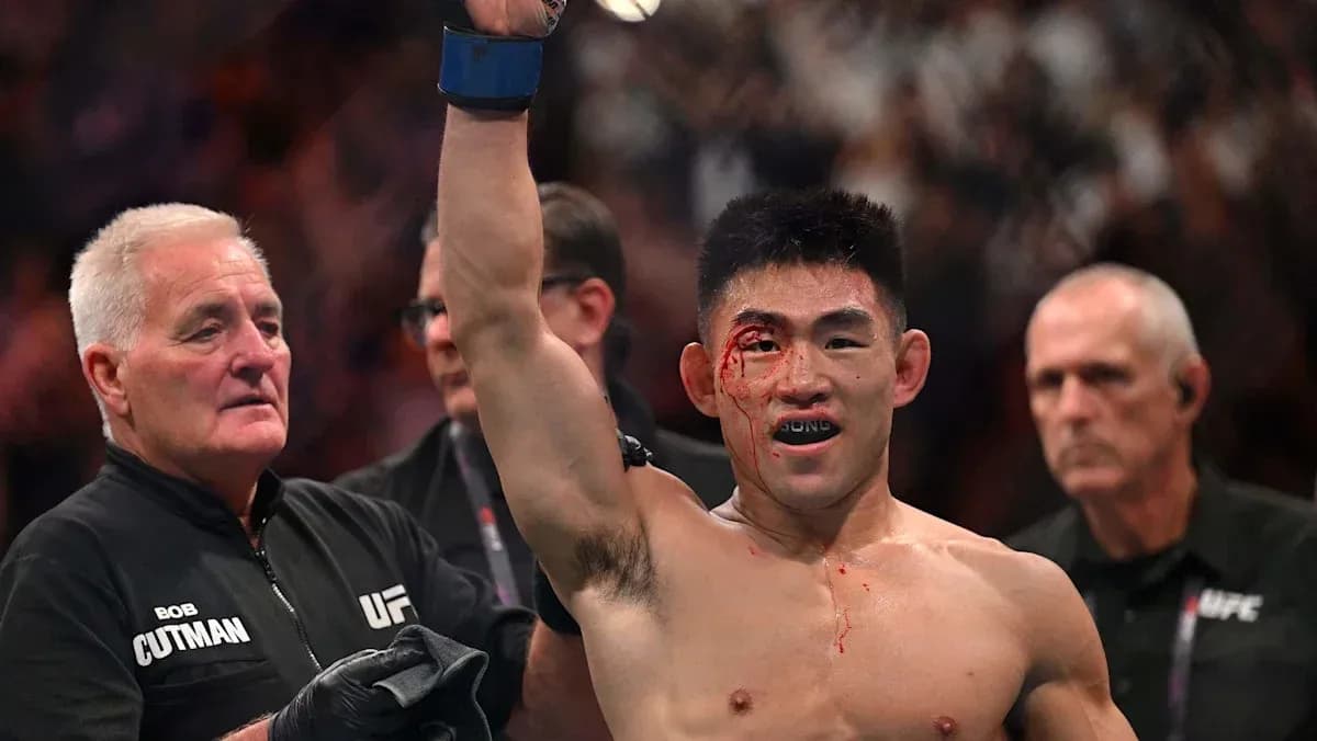 Fighter celebrating victory with a bloodied face