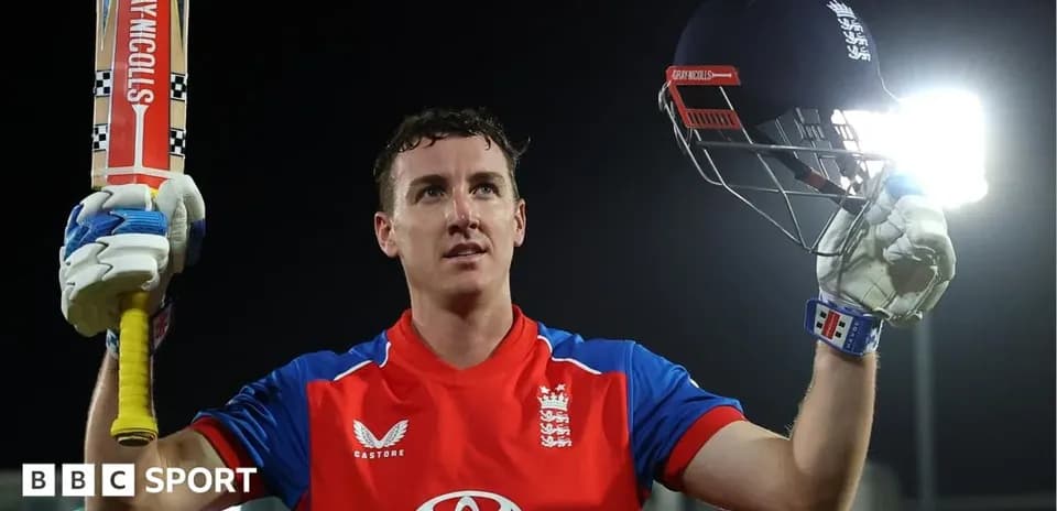 Batsman celebrating with helmet and bat raised