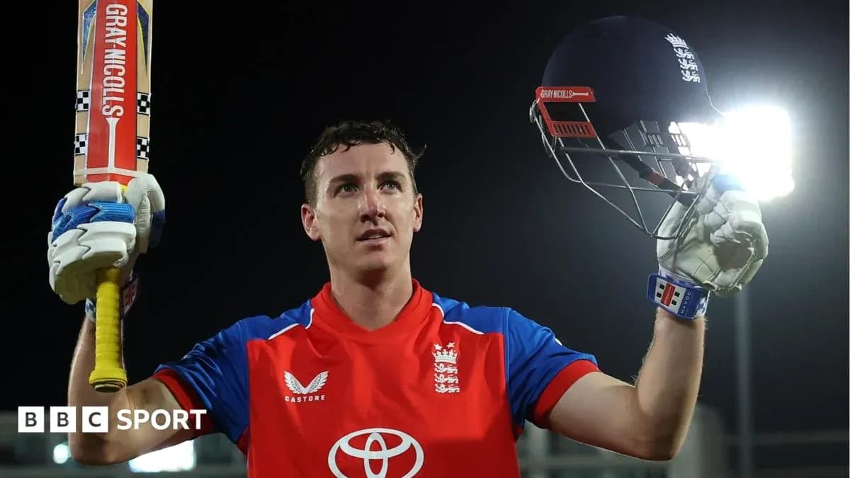 Batsman celebrating with helmet and bat raised