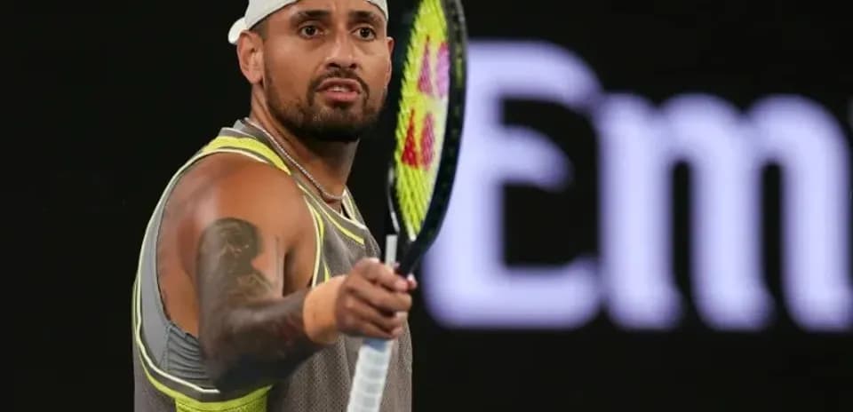 Tennis player preparing to serve during match