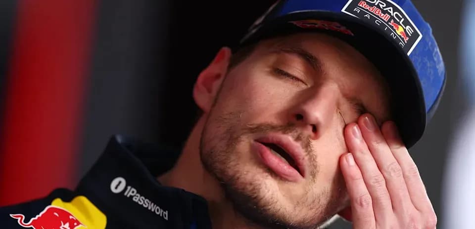 Driver resting during a press conference appearance