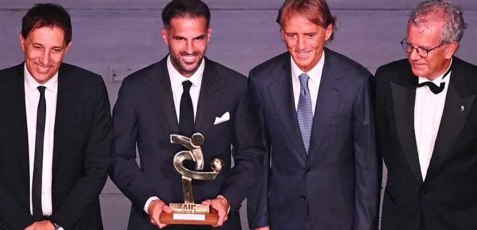 Four men holding an award at a ceremony