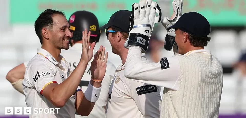 Players celebrating a wicket during a cricket match