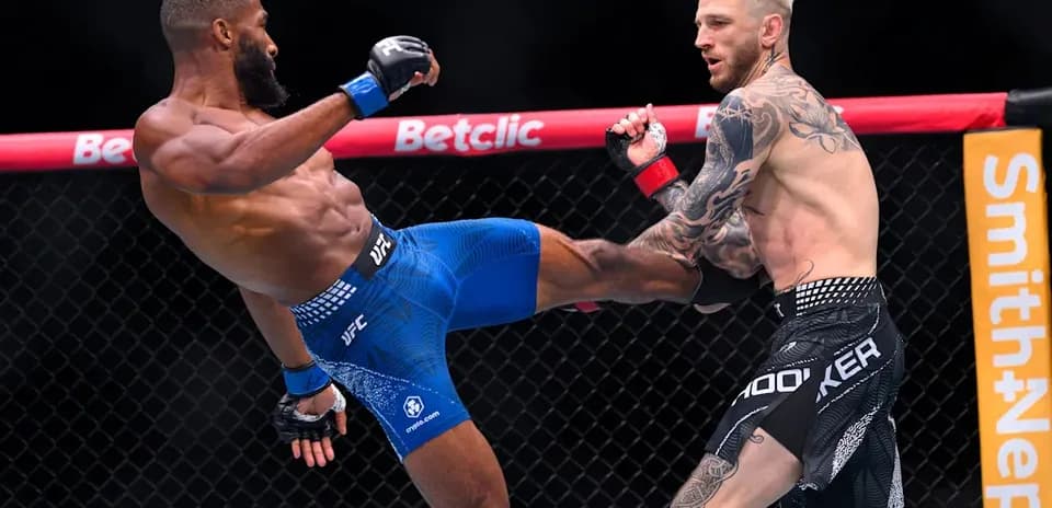 Two fighters engaged in an MMA match in octagon