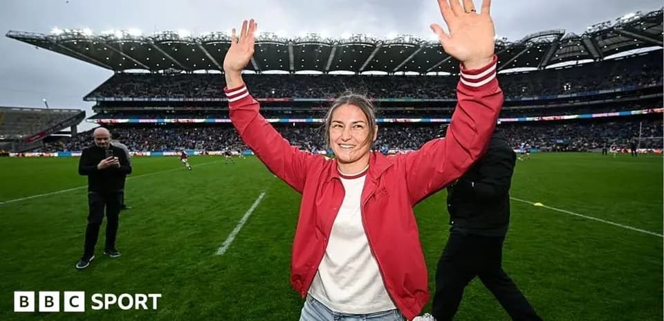 Woman celebrating with raised hands on rugby field