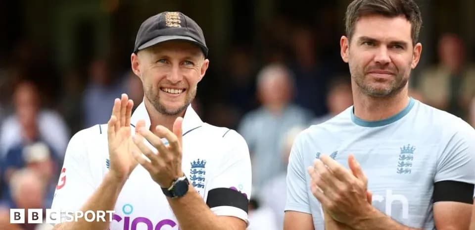 Two cricket players applauding on the field