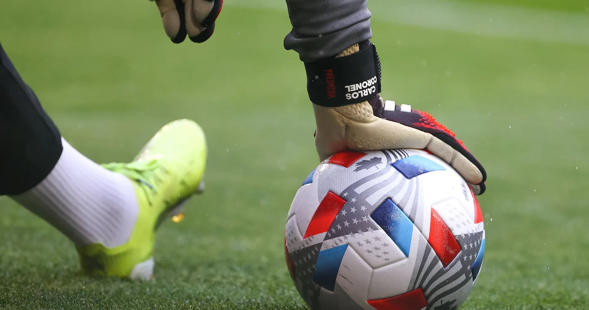 Goalkeeper placing ball on field during match