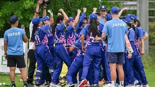 Japanese women's cricket team celebrating on field