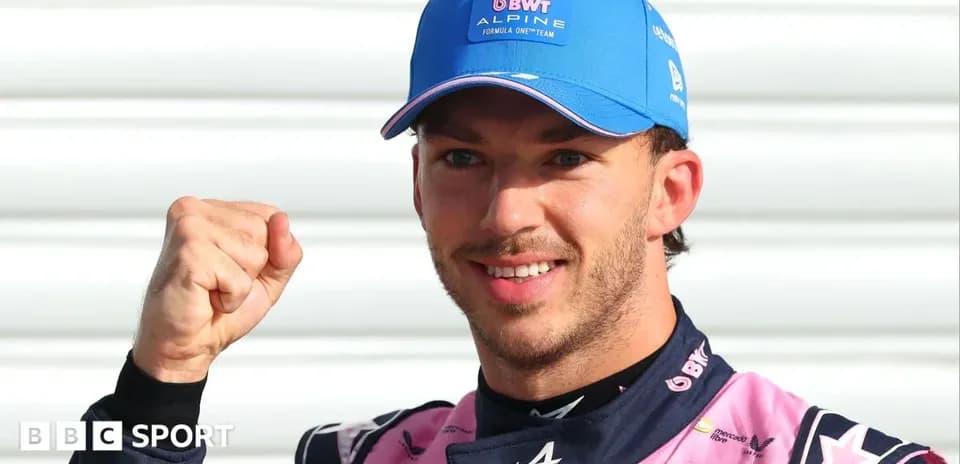 Driver celebrating with a fist pump in team uniform