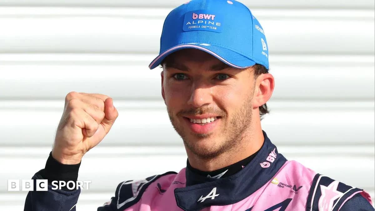 Driver celebrating with a fist pump in team uniform