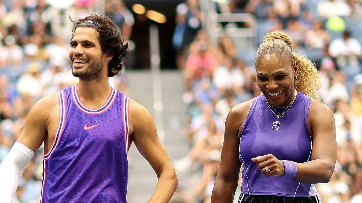 Two tennis players smiling on the court