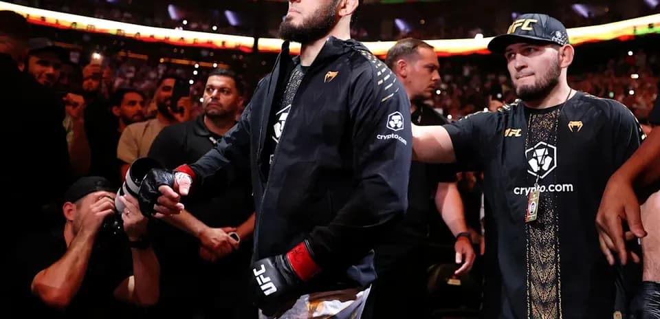 Fighter walking to the octagon surrounded by fans