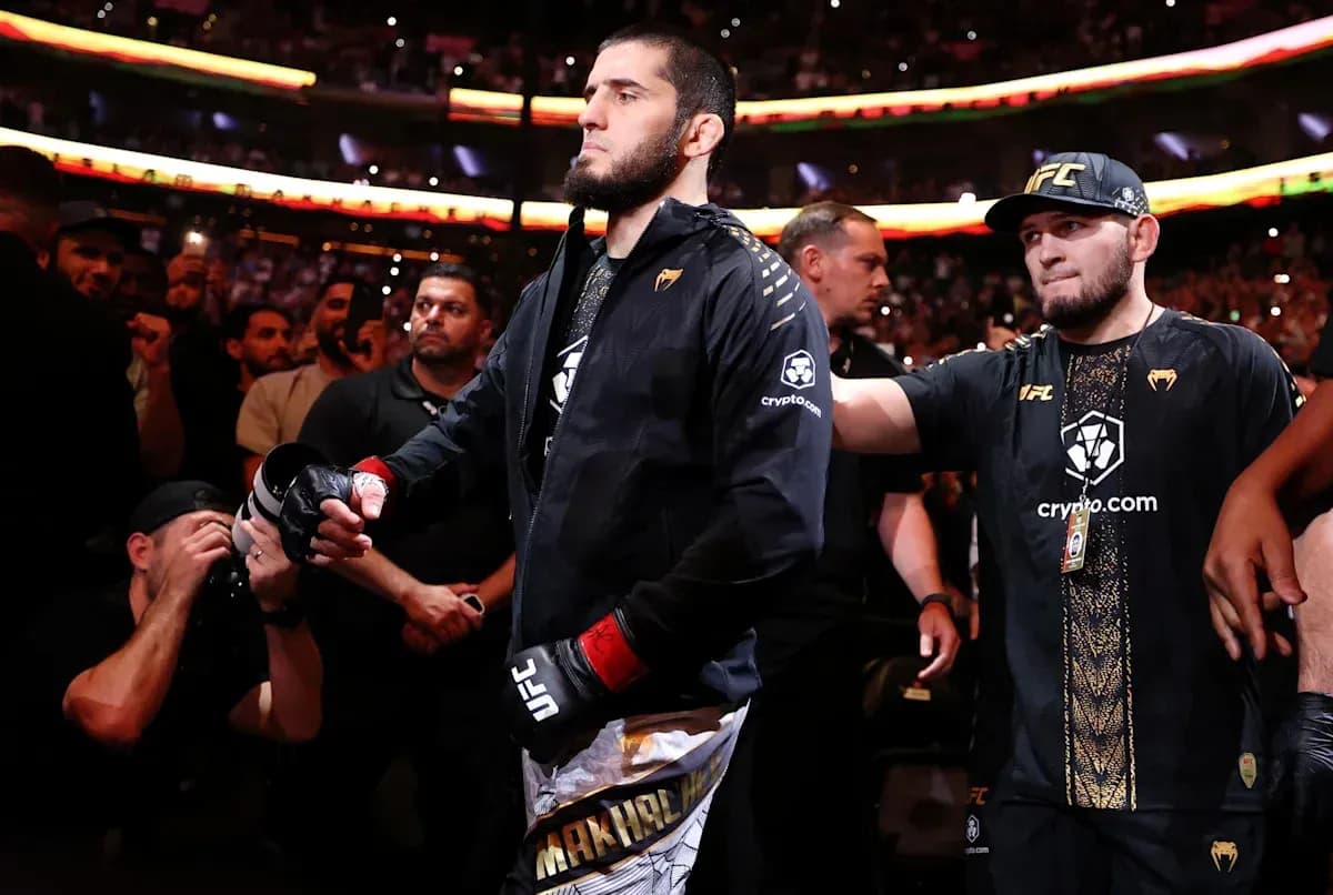 Fighter walking to the octagon surrounded by fans
