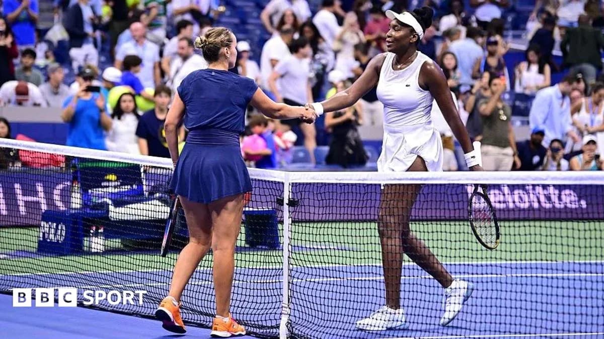 Two tennis players shaking hands at the net